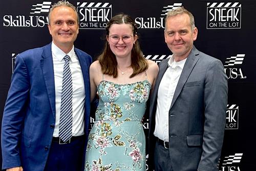 Samantha poses with two judges at nationals